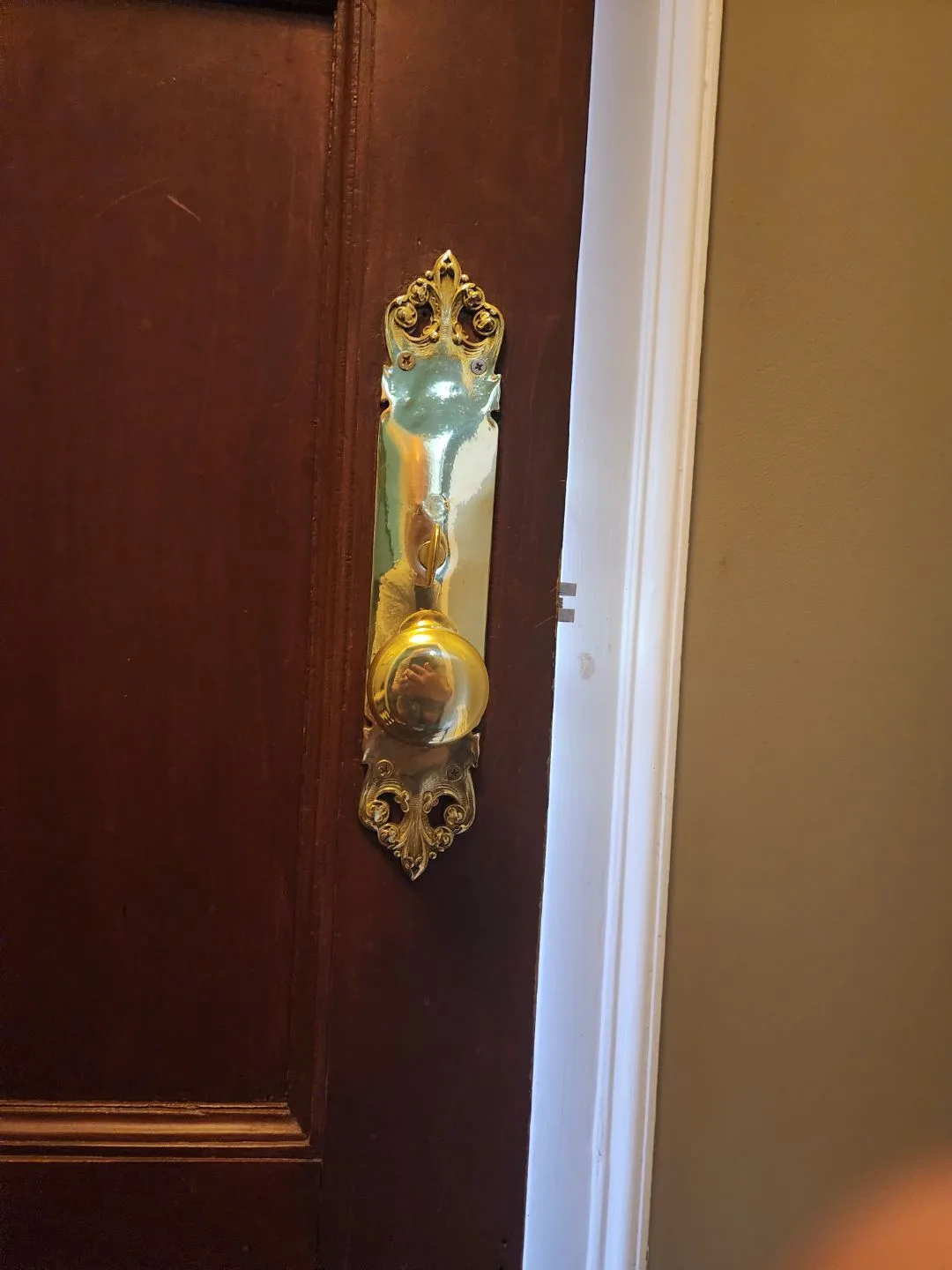 Brass entry lock and handle on a wooden door