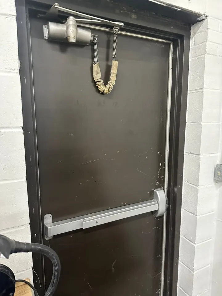 Commercial exit door with panic bar and overhead door closer