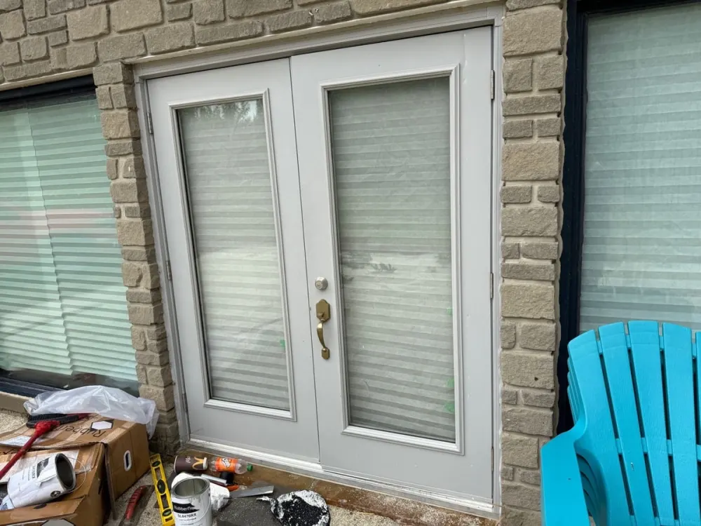 Double residential entry doors with brass lock hardware